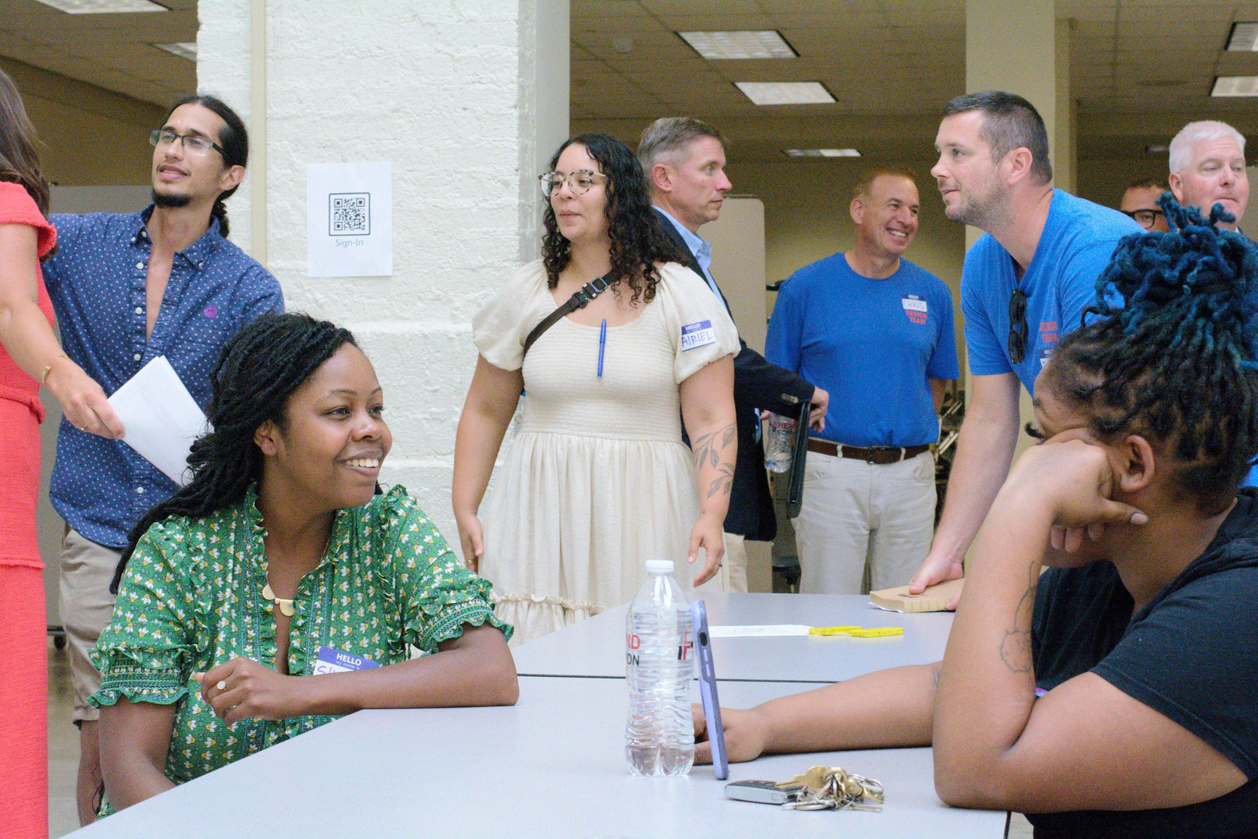 A group of people engaging in conversation at an event.
